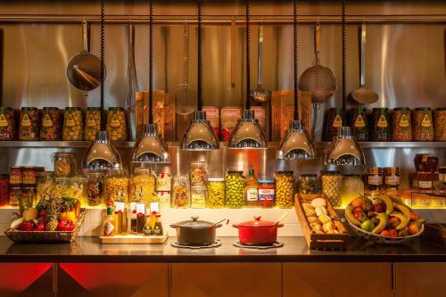a kitchen with a counter with many different types of food at citizenM Amsterdam South in Amsterdam