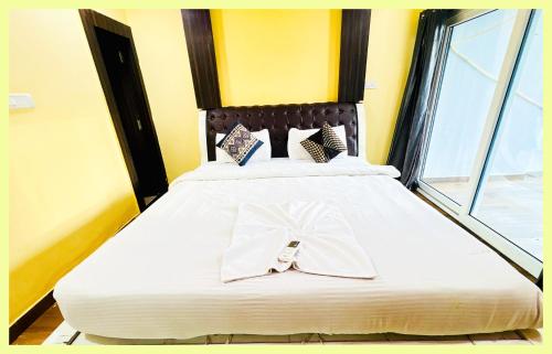 En eller flere senge i et værelse på The Drimea Hapur UP