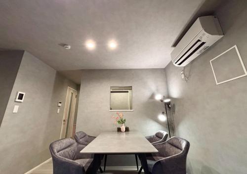 a room with a table and chairs in a room at SALE Flawed Property with a loud music from neighbor but stay cheap in nice area in Tokyo