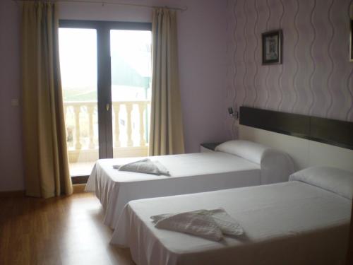 เตียงในห้องที่ Hotel Gardu