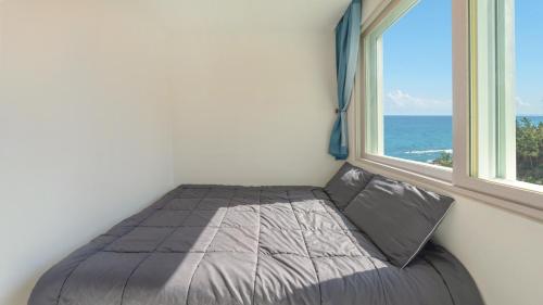 una cama en una habitación con ventana en yeongdeok chaeumneul poolvilla, en Yŏngdŏk