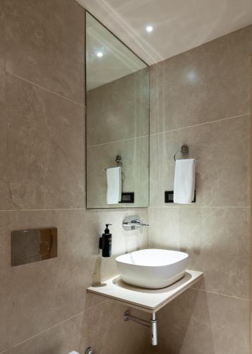 a bathroom with a sink and a mirror at JALSA HOTEL & BANQUETS,Indore in Indore