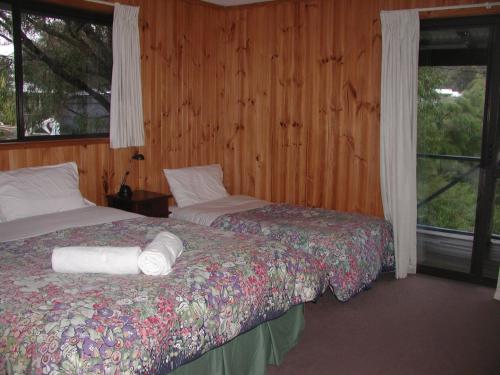 a bedroom with two beds and a window at Rainbow House in Denmark