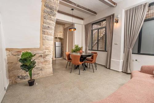 a dining room with a table and chairs in a room at Moses Luxury apartments 36 a in Safed