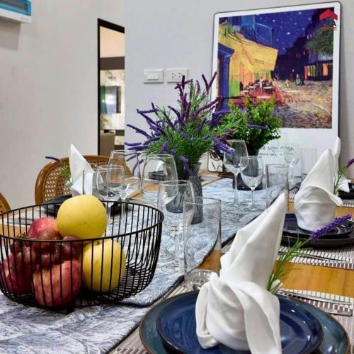 a table with glasses and fruit in baskets on it at Aqua pool villa in Ban Nong Thale