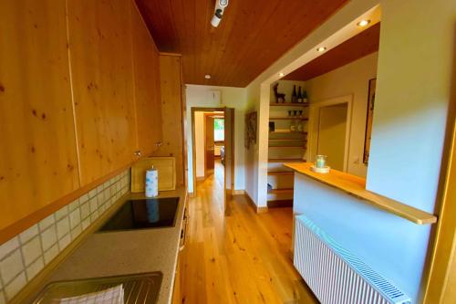 a kitchen with wooden walls and a counter top at Ferienhaus Rothaarblick in Schmallenberg