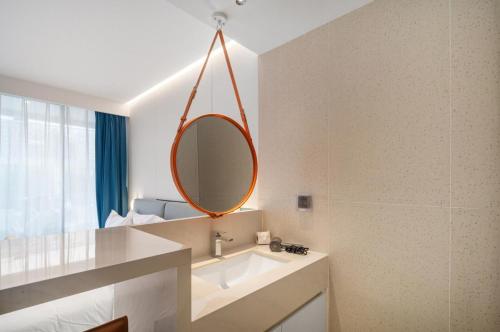 a bathroom with a sink and a mirror at Premier Pool View Studio 348 KoraResort in Layan Beach