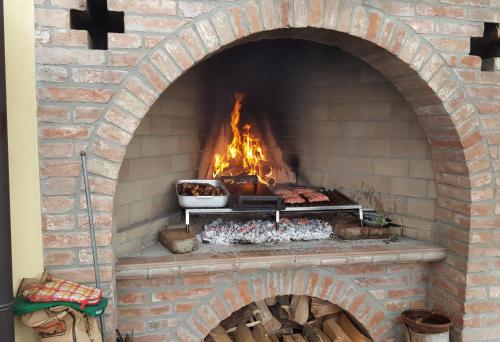 a brick oven with a fire in it at Luna Residence Hotel in Casalmaggiore