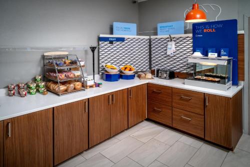 a bakery with a counter with food on it at Holiday Inn Express & Suites Cross Lanes by IHG in Cross Lanes