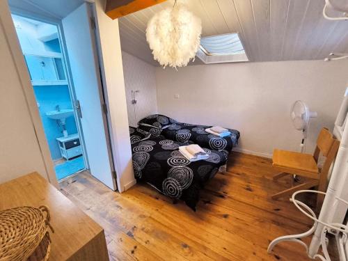 a bedroom with a bed in a room with a chandelier at La Maison de la Baume in Volonne