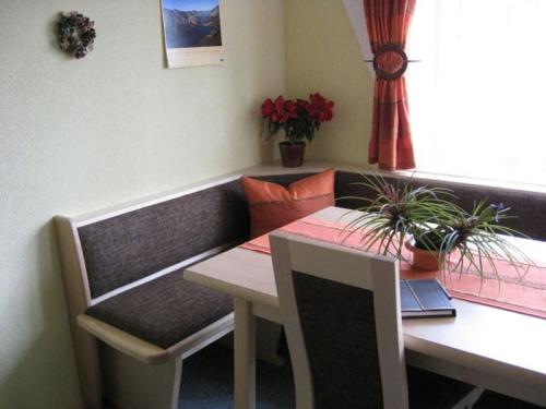 a room with a table and a bench and a table and a table at Ferienwohnung Stickler in Reutte