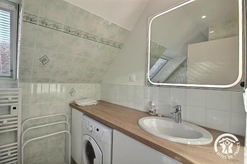 a bathroom with a sink and a mirror at Le balcon de la baie in Paimpol