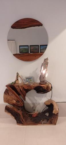 a table made out of a piece of wood with a mirror at Khrisna Mooi villa 2 BR in Tulamben