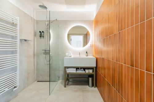 a bathroom with a sink and a mirror at FortyPlusOne Hotel Vienna in Vienna