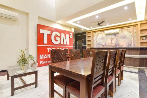 a dining room with a table and chairs at FabHotel The Grand Manmuralidhar - Hawa mahal 3 km, Chandpol metro station in Jaipur