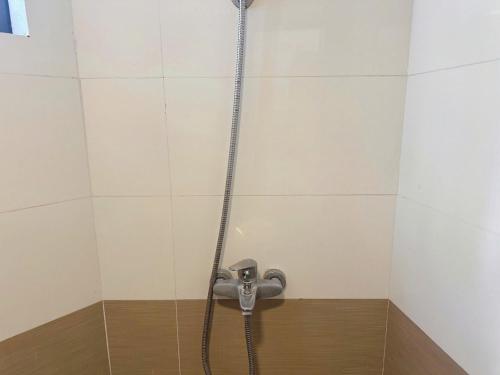 a shower in a bathroom with a hose at Phương Đông 502DT in Hanoi
