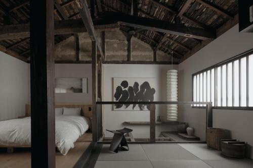 a bedroom with a bed and a bed and a table at Haku-ma 白間 in Kanazawa