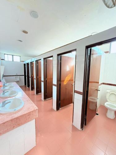 a bathroom with a row of sinks and toilets at Met Blue Ocean Resort in Mersing