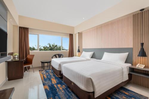 Ένα ή περισσότερα κρεβάτια σε δωμάτιο στο Aston Cimone Hotel & Convention Center