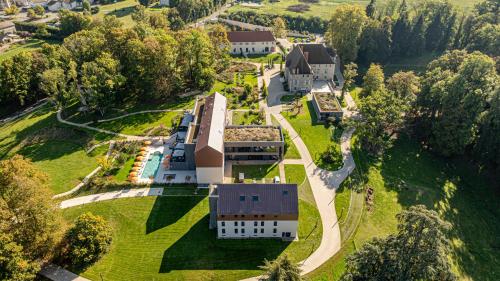 an aerial view of a building on a green field at Domaine de Dolomieu Hotel & Spa - BW Premier Collection in Dolomieux