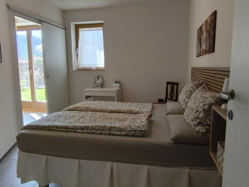 a bedroom with a large bed and a window at Villa Raggio di Sole in Abbadia Lariana