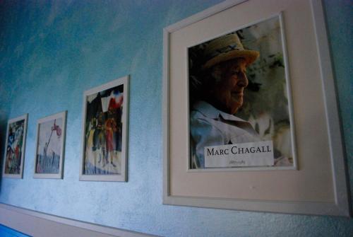 a framed picture of a man in a hat on a wall at Hotel Diana in Ravenna