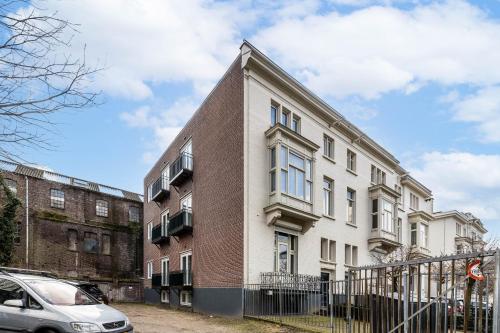 a brick and white building with a car parked in front at Raiffeisenstraat Eindhoven in Eindhoven