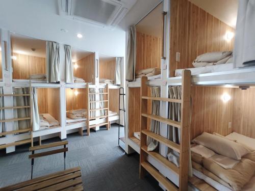 a room filled with lots of bunk beds at KOREGA ! Hostel Osaka Namba in Osaka