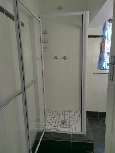 a shower with a glass door in a bathroom at WegkruiperQ 2 in Beaufort West