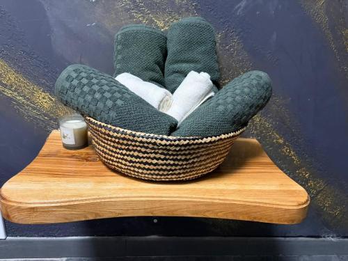 a basket filled with towels on a wooden table at Wild Hill Apuseni in Gârda de Sus