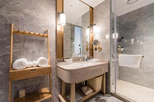 a bathroom with a sink and a shower at Atour S Hotel SHanghai Baoshan Gucun Park in Shanghai