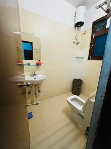 a bathroom with a toilet and a sink at Hotel Lake Vista Stays in Udaipur