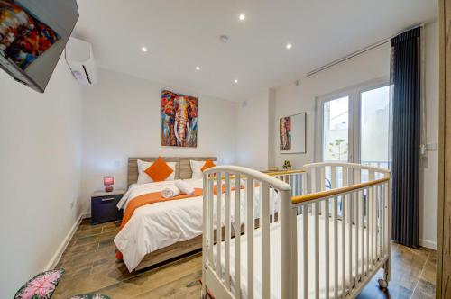 a white bedroom with a bed and a window at Ridge View Rooms - in a Shared Apartment - Sea Views in Mellieħa
