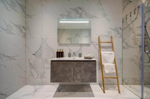 a bathroom with a sink and a mirror at Ridge View Rooms - in a Shared Apartment - Sea Views in Mellieħa