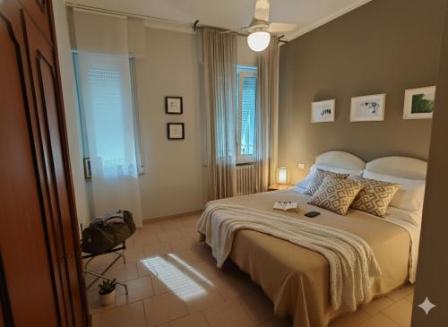 a bedroom with a large bed in a room at Residence Appartamenti Casa Vacanze Abbazia in Pesaro