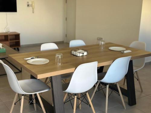 a large wooden table with white chairs around it at Two Bedrooms Apartment with Private Balcony in Yukarı Lakatamya