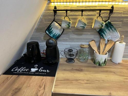a coffee bar with cups and utensils on a counter at Borovi30 in Divčibare