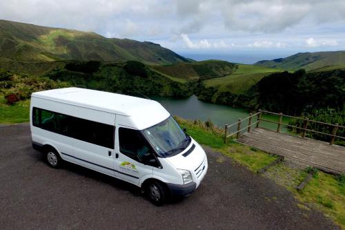 a white van parked on a road near a river at Aldeia da Cuada in Faja Grande