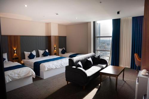 Ένα ή περισσότερα κρεβάτια σε δωμάτιο στο Wlat Hotel