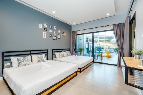 Giường trong phòng chung tại Lom-Talay poolvilla huahin
