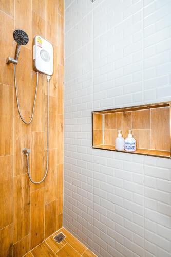 a shower with a shower head in a bathroom at Lom-Talay poolvilla huahin in Hua Hin