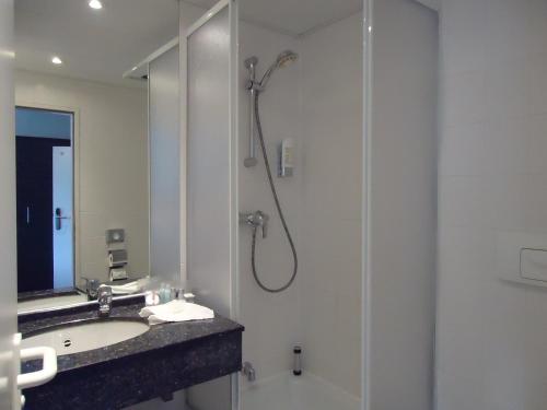 a bathroom with a shower and a sink at MSR Hotel Hannover in Hannover