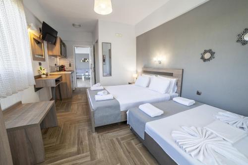 a hotel room with two beds and a kitchen at Dream Studios in Stavros