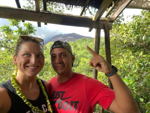a man and a woman posing for a picture at Yasur Backpackers Bungalow & Tree House in Tanna Island