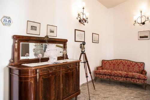 a room with a camera and a fish tank next to a couch at Hotel Villa Enrica - Aeolian Charme in Lipari