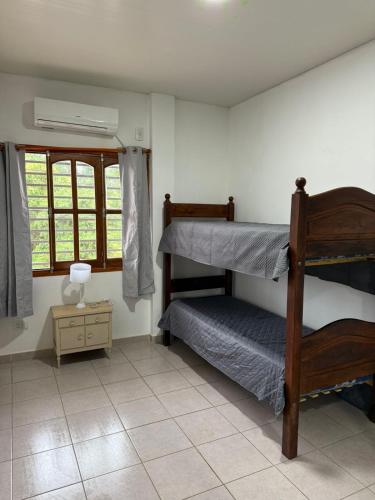 a bedroom with two bunk beds and a window at Departamento a pocos pasos de la ruta 12 in Eldorado