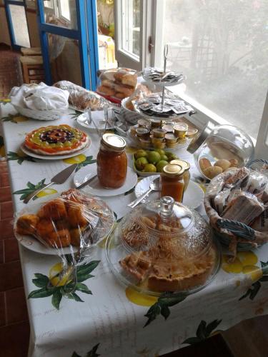 a table with many plates of food on it at La Casa del Limoneto in Favignana