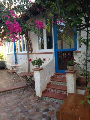 a house with a blue door and some flowers at La Casa del Limoneto in Favignana