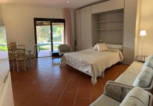a bedroom with two beds and a table and chairs at Appartamento Stintino in Cuile Pazzoni