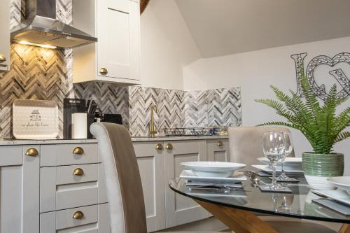 a kitchen with a glass table and a counter at Blists Hill Cottage Near Ironbridge Victorian Museum in Telford